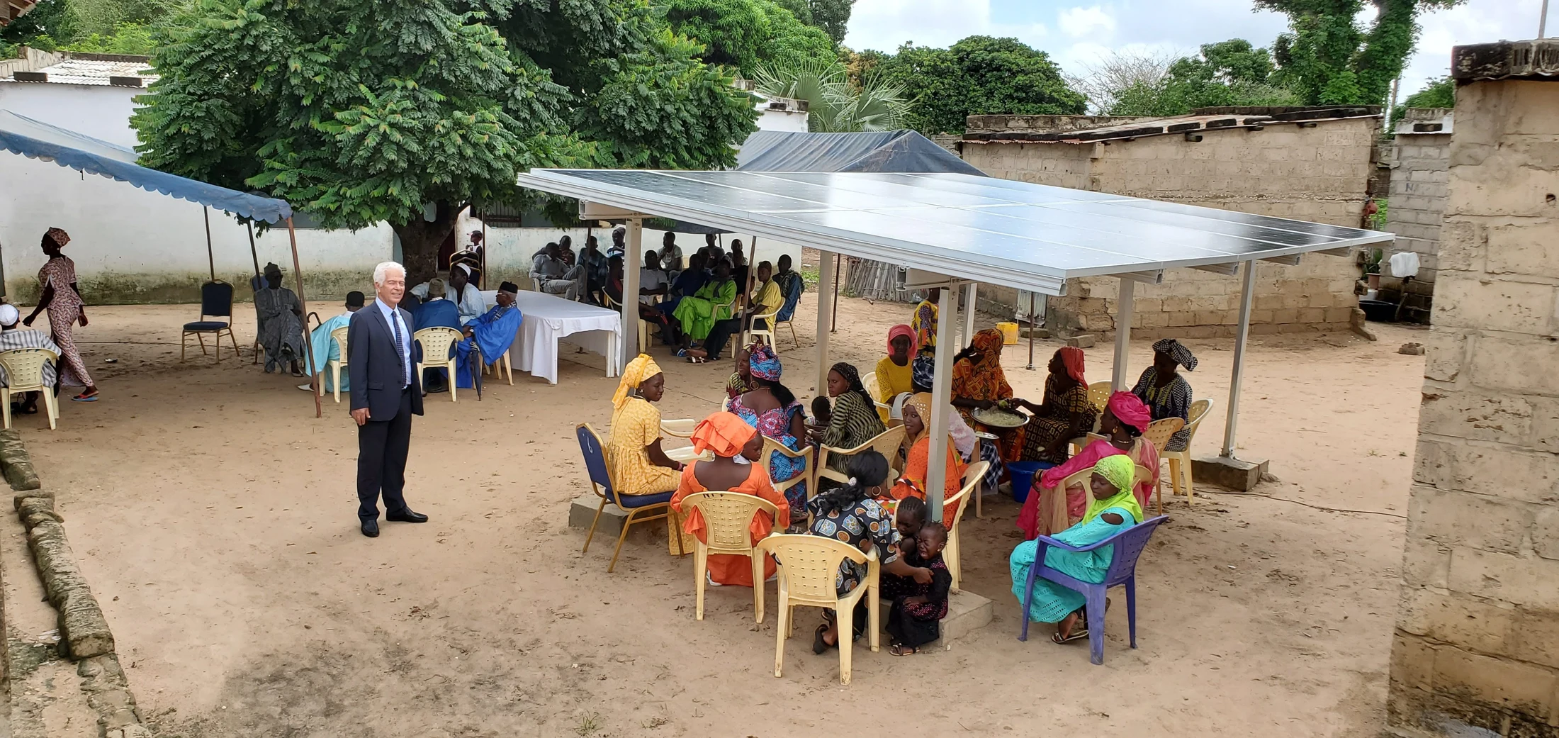 Community gathering at a village solar project in Africa